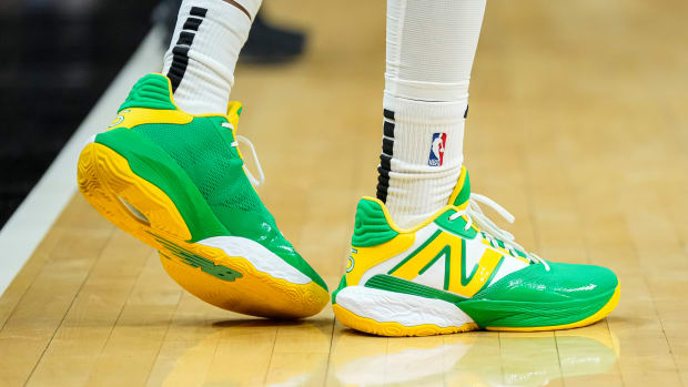 Atlanta Hawks guard Dejounte Murray's green and yellow New Balance shoes.